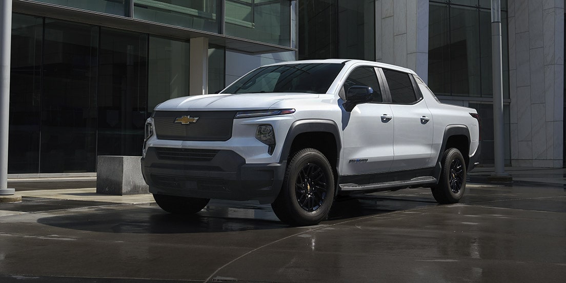 A GM Fleet EV parked outside a modern building.