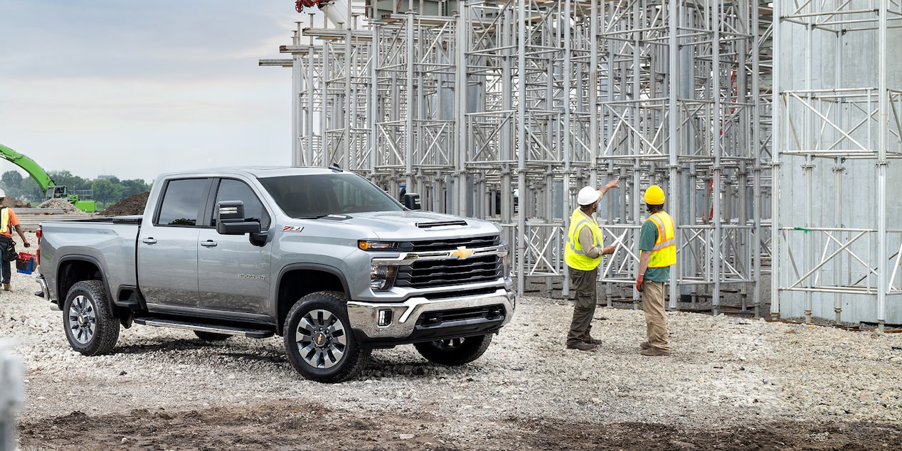 Side view of a GM Fleet truck parked at a construction site.