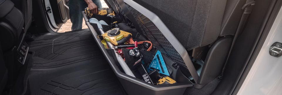 Tools being stored in a compartment inside a GM Fleet vehicle.