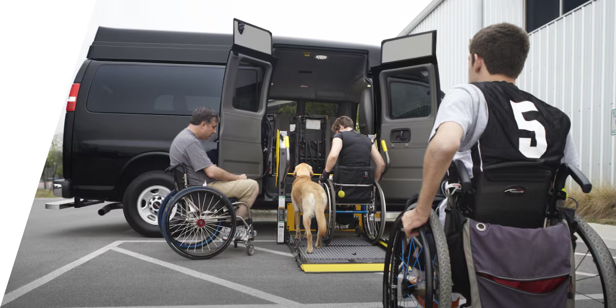 Three people in wheelchairs using the upfit wheelchair lift application.