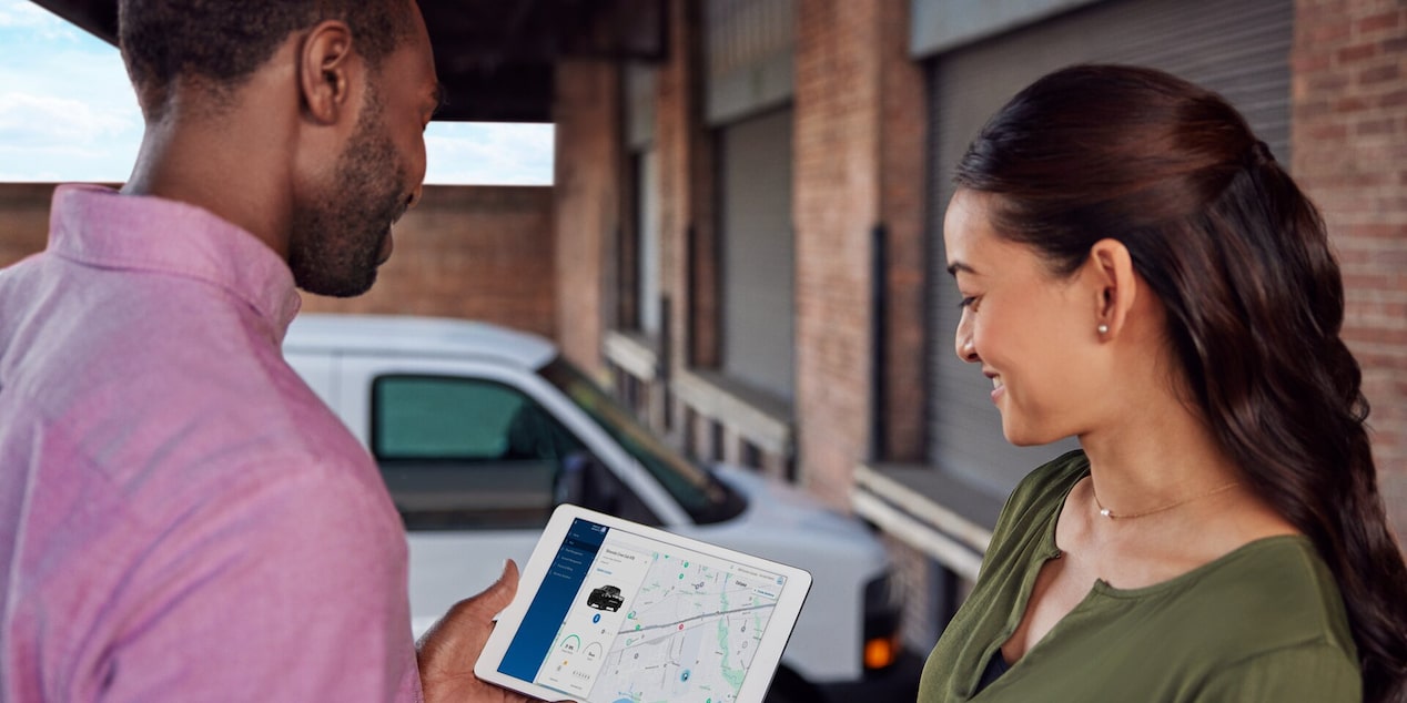 A person accessing real-time info on a GM Fleet vehicle from a smart tablet.